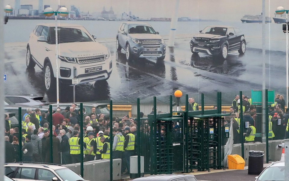 Staff gather outside the Jaguar Land Rover site in Halewood, Knowsley, Merseyside