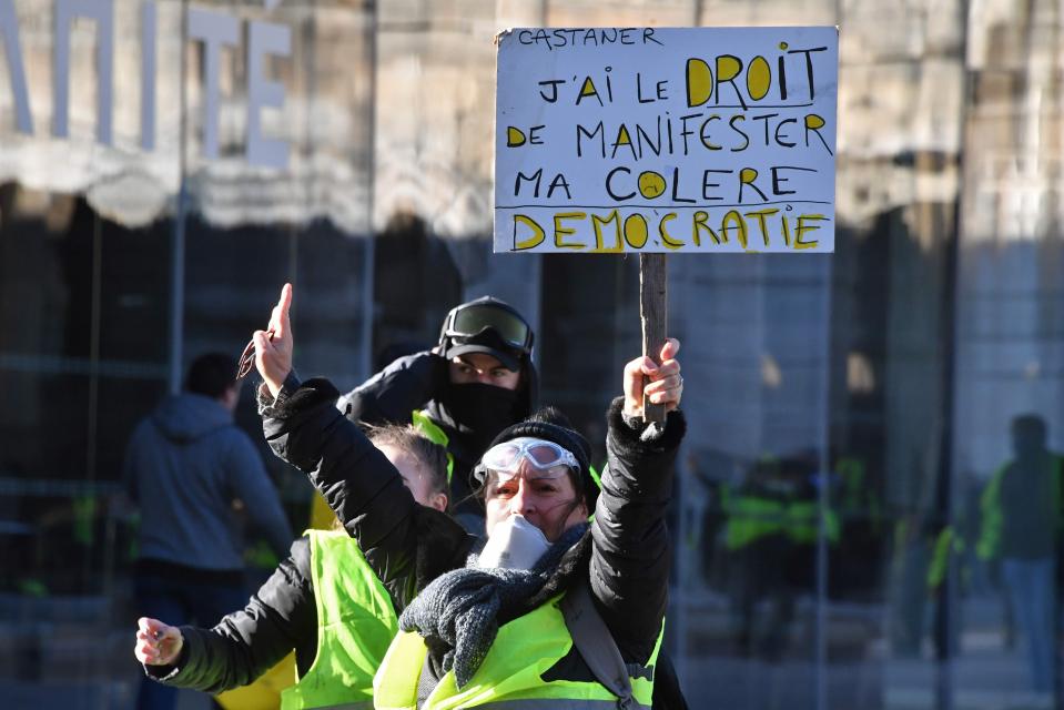  Demonstrators hold a placard reading 'Castaner, I have the right to show my anger: Democracy'