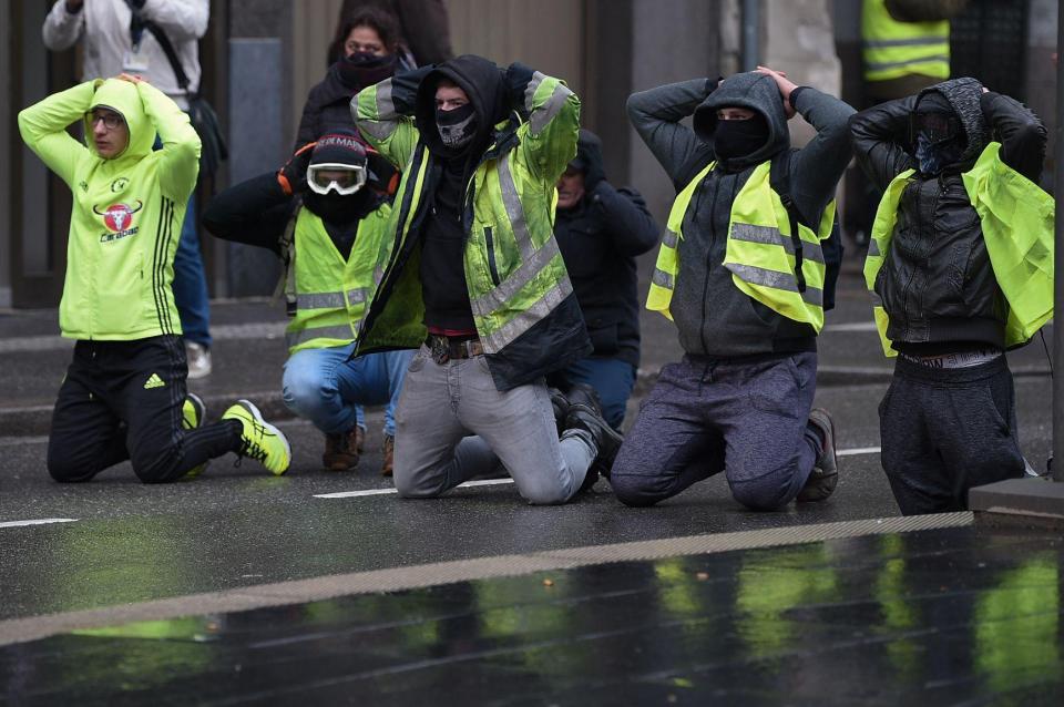  Yellow vest protesters re-enact the students' arrest in Mantes-la-Jolie during an anti-government demonstration