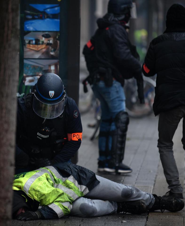  Riot police detain a protester during clashes