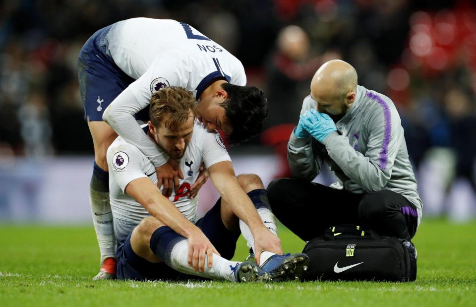  Heung-Min Son trying to console the injured Spurs striker