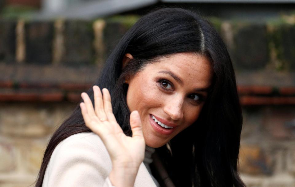  The stunning duchess waves as she leaves the charity