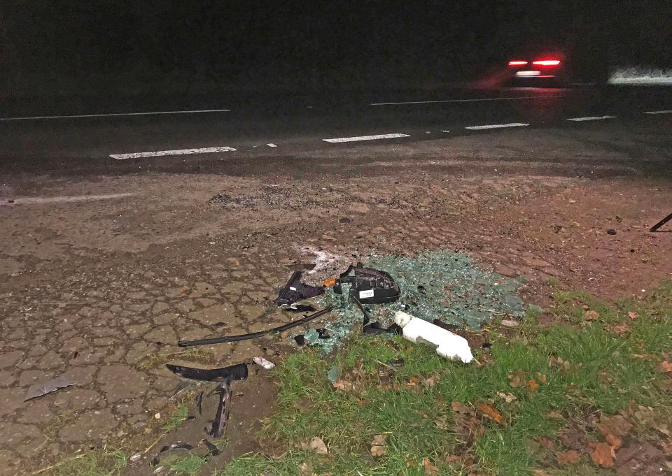  Pieces of broken glass and the remnants of a wing mirror at the crash scene