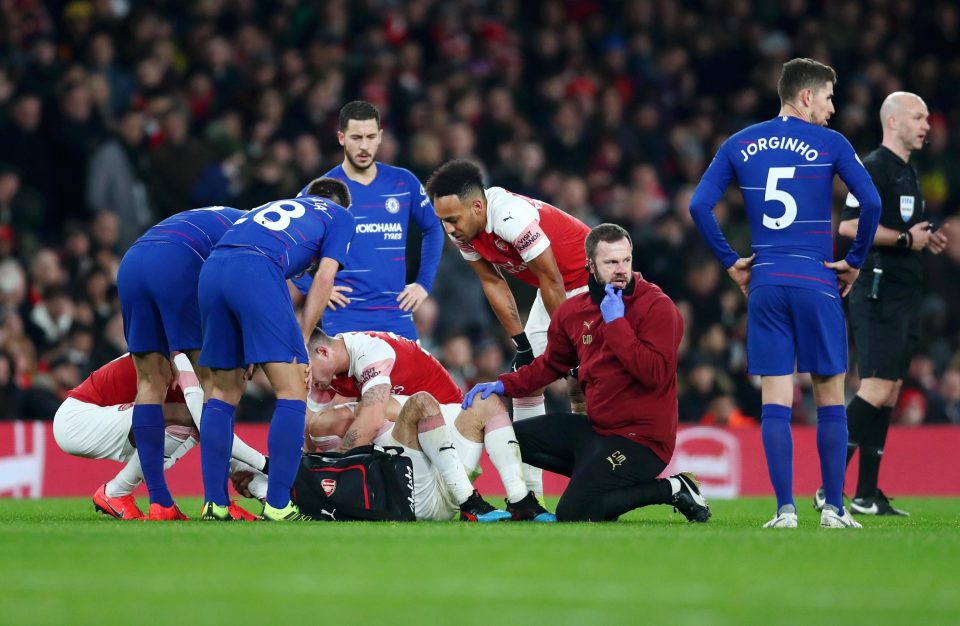  A medic treats Hector Bellerin after he suffers a horror knee injury