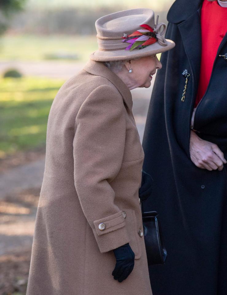  Ever practical, the Queen also wore warm black gloves