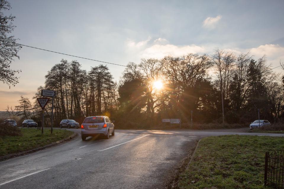  New shots show the piercing winter sun shining between the trees lining the A149 near Sandringham, Norfolk