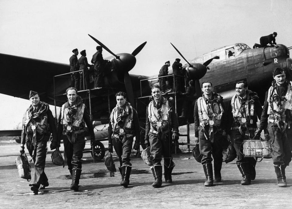  The crew of a Lancaster bomber return from a sortie in 1943, as ground crew move in to check the plane over