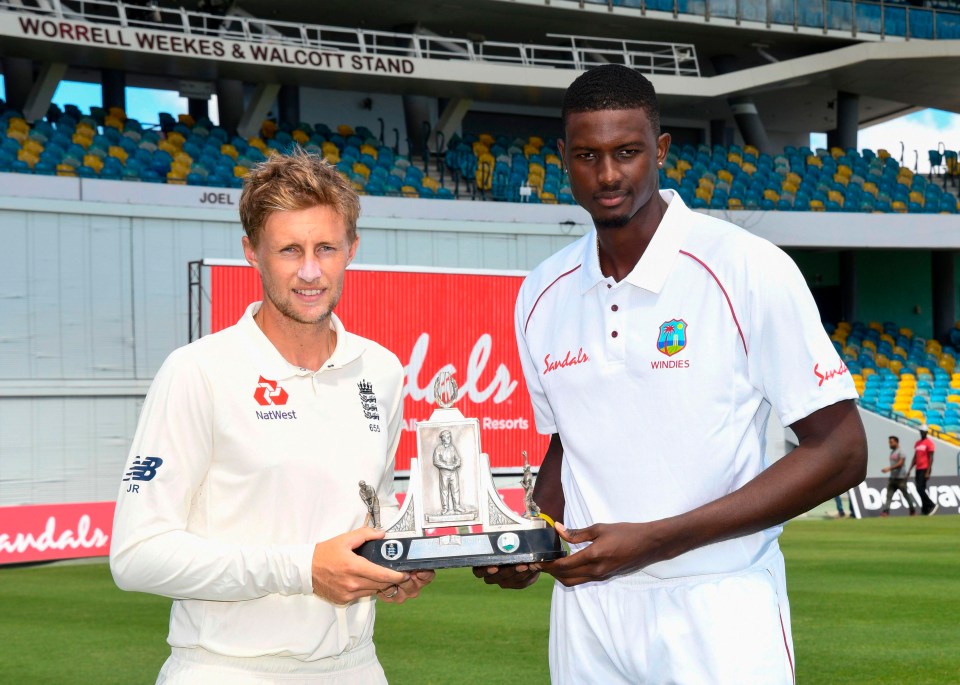 Root holds the Wisden trophy along with Jason Holder ahead of the First Test