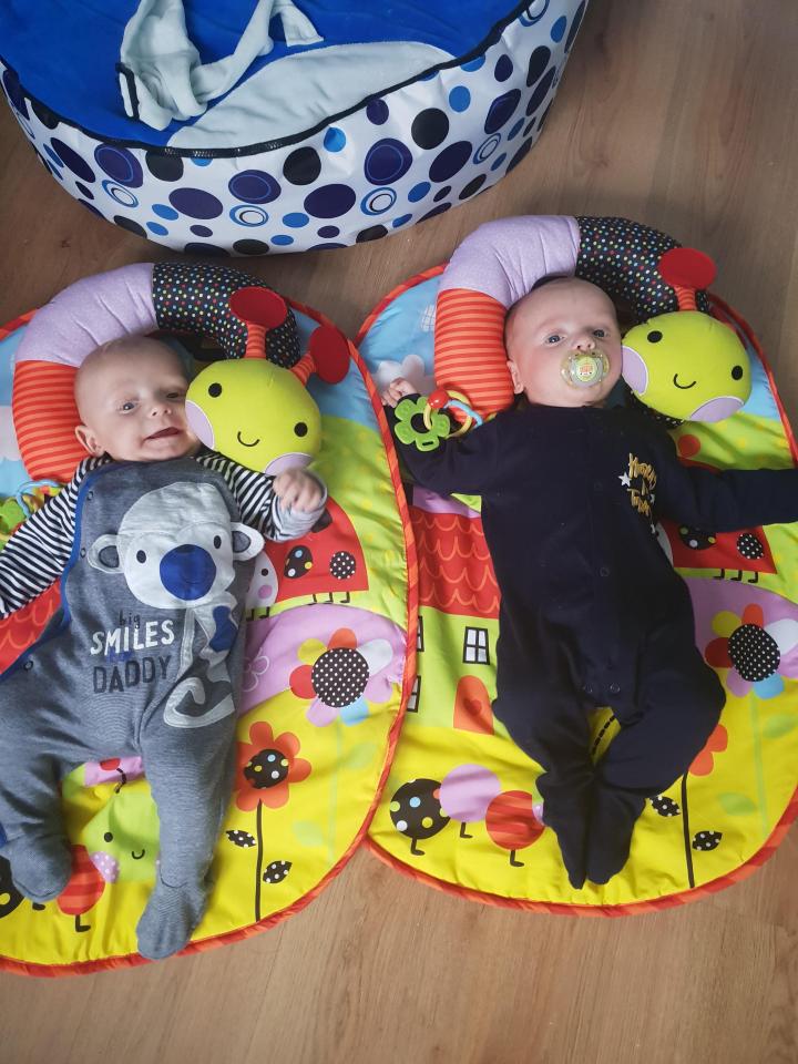  The twins playing on a mat