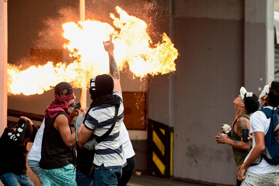  Shocking pictures show masked men burning cars and buildings