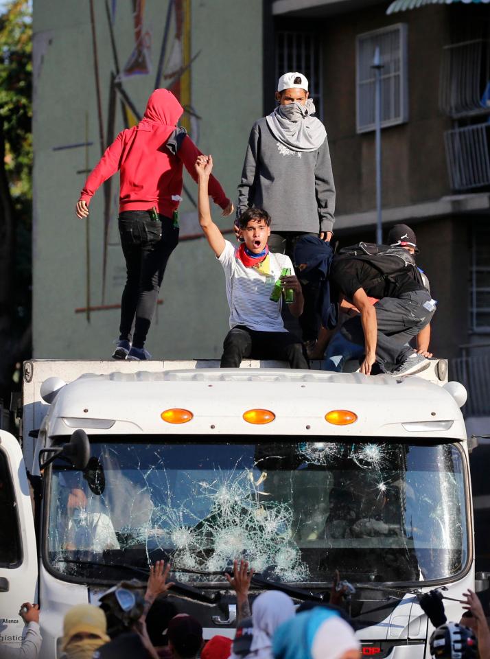  Demonstrators smashed up cars and jumped onto trucks