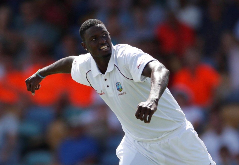 Jason Holder celebrates ripping through England on day two of the first Test