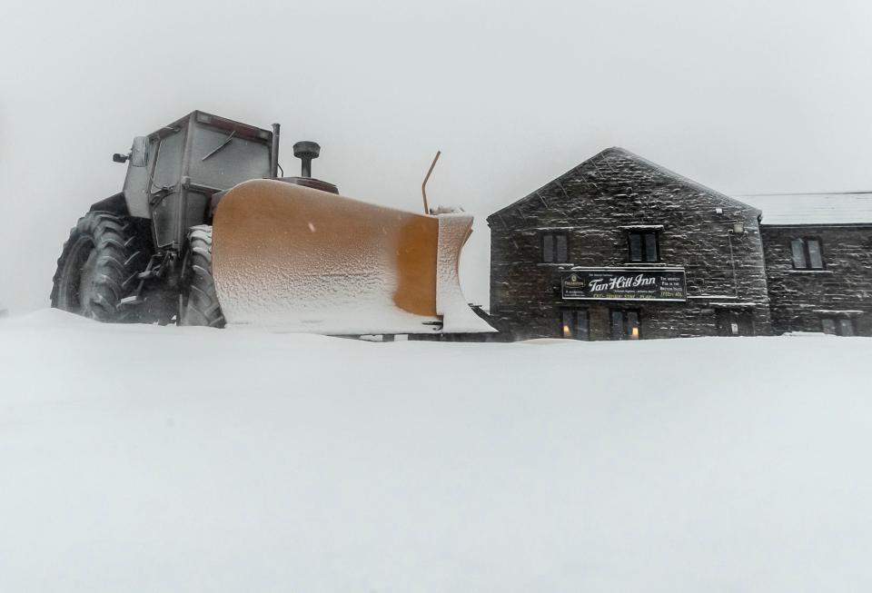  A snowplough in wintry conditions outside the Tan Hill Inn in North Yorkshire