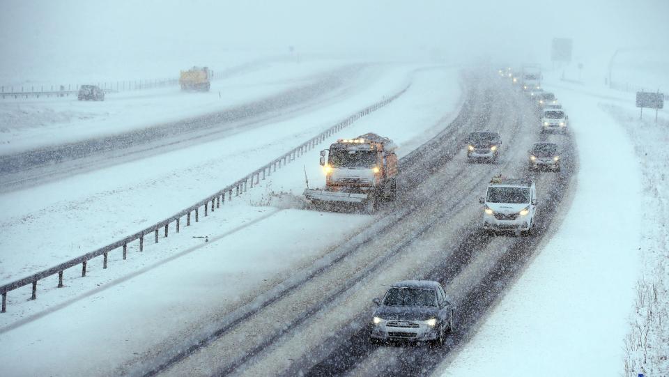  A snowplow clears a lane on the M6 near the village of Shap in Cumbria