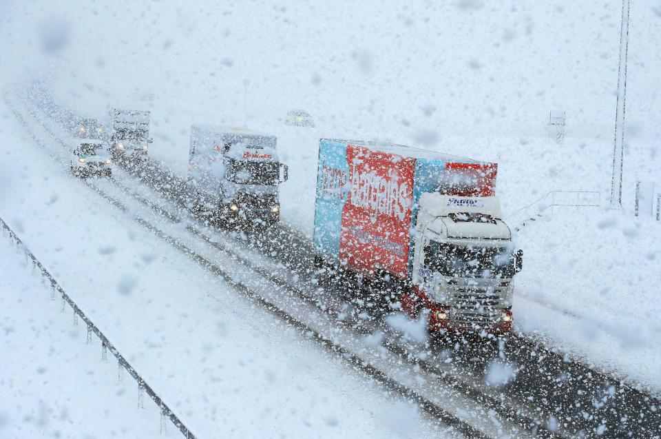  Lorries navigate through the snow on the A6 near the village of Shap in Cumbria