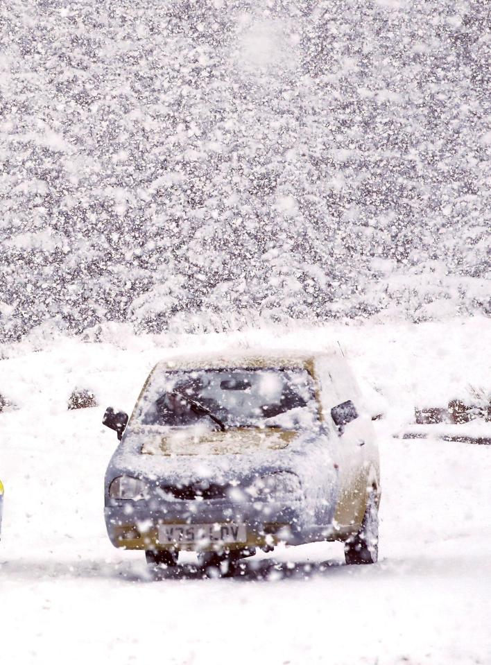  A three-wheel Reliant Robin tackles the heavy snow in Shap, Cumbria