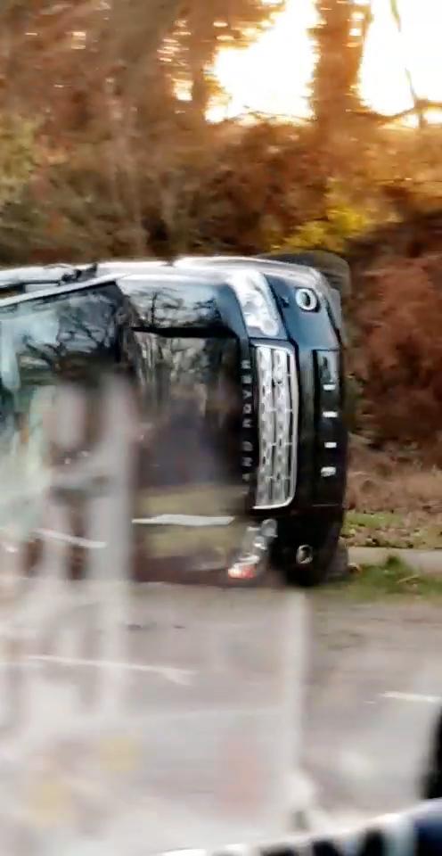  Footage shows Prince Philip's Land Rover on its side by the verge