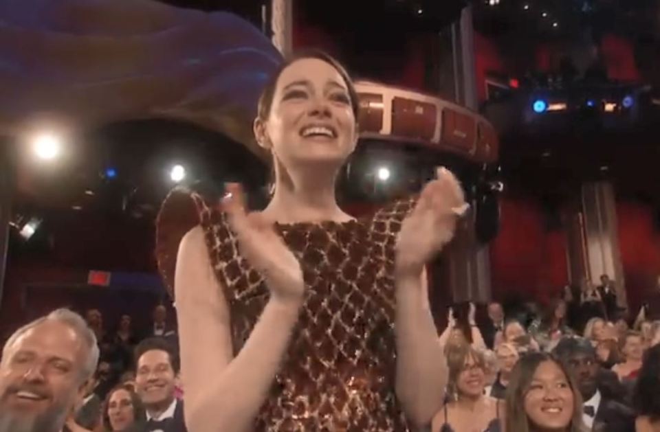  Emma was on her feet as Olivia accepted the award