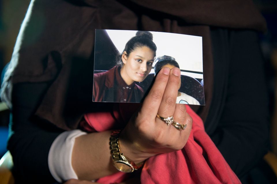  Renu, eldest sister of Shamima Begum, 15, holds her sister's photo while being interviewed by the media