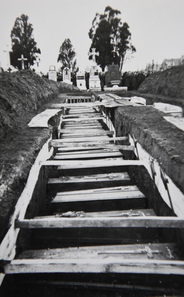 A photo taken on Decembre 5, 2018 in Villeneuve-d'Ascq, northern France, shows a reproduction of a photograph showing coffins after the massacre of Ascq in 1944 during WWII