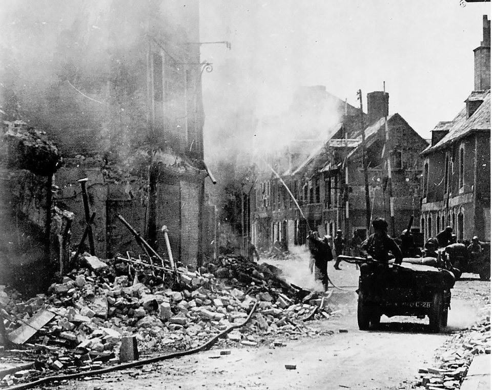  Rubble and burning houses in Carentan near Normandy, where the Germans wanted to re-establish their defence of the town