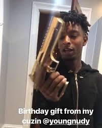  21 Savage poses with a gun on Instagram