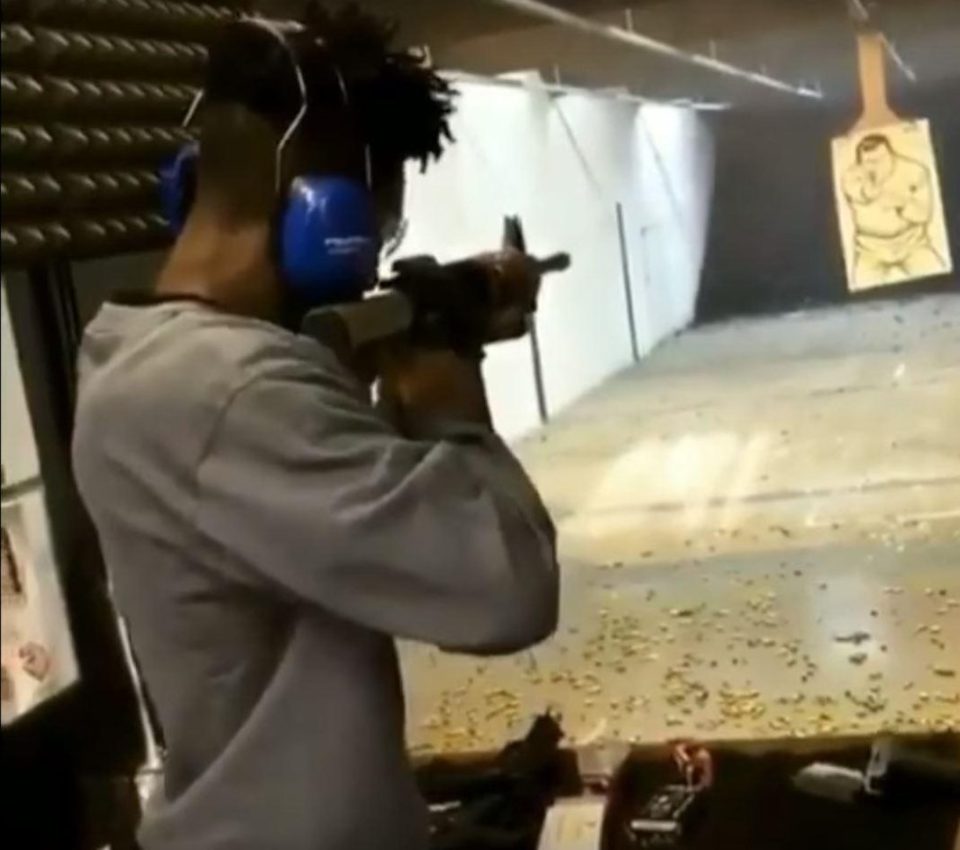  21 Savage pictured firing a gun at a shooting range