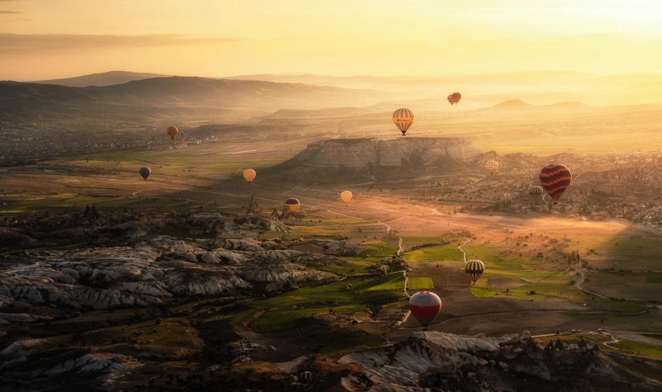 Balloons floating in the air among the sunshine in the morning in Cappadocia,Turkey