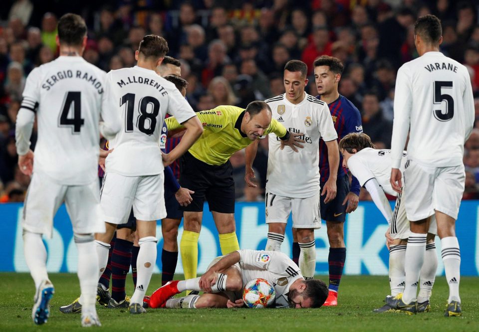  Real Madrid defender Dani Carvajal is down injured as ref Antonio Miguel Mateu Lahoz looks on