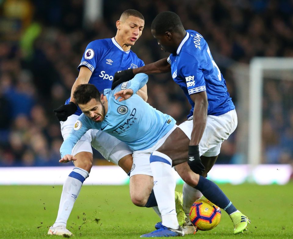  Bernardo Silva is caught by two Everton players in Manchester City's 2-0 win at Goodison Park