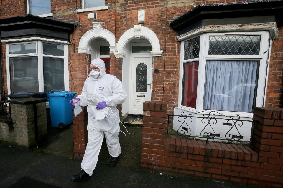  Forensic officers search the suspect's home