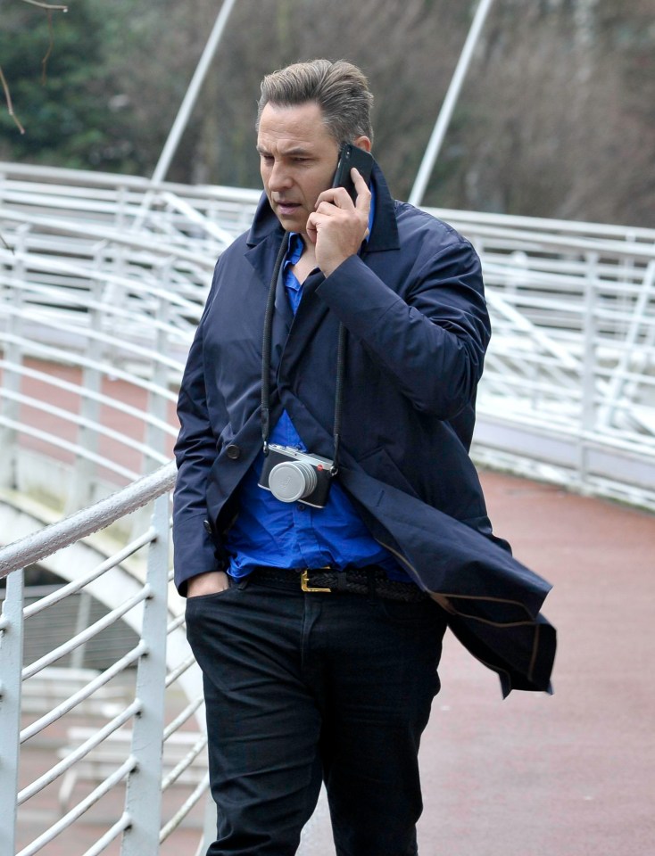 David looked grumpy as he chatted on his phone during a stroll