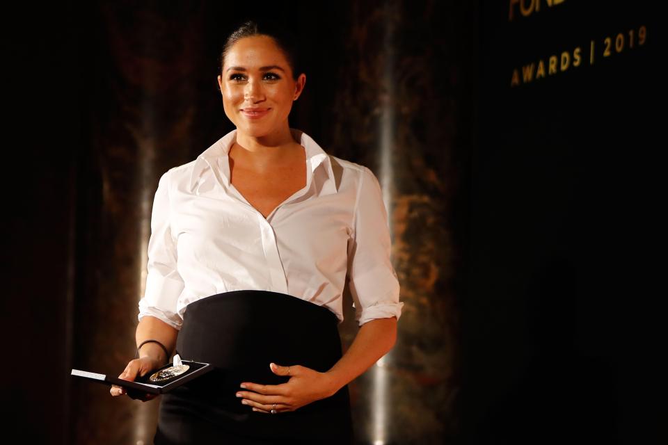  Meghan clutched her baby bump at last week's Endeavour Fund Awards at Drapers Hall