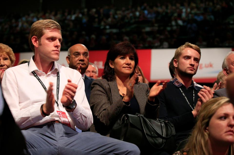  Ben Corbyn (left) and Thomas Corbyn (right), the sons o along with his wife Laura Alvarez, applaud during his first keynote speech on day three of the Labour Party annual conference at the Brighton Centre in Brighton, Sussex