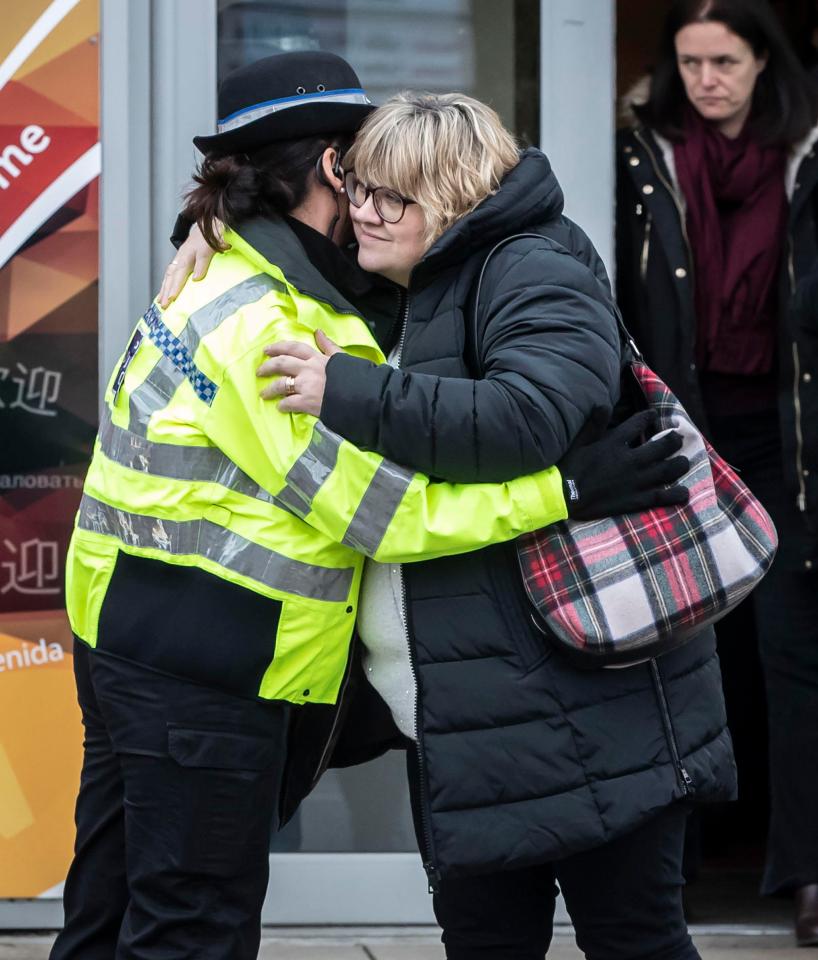  Libby's mum Lisa hugs a police officer outside a church service today