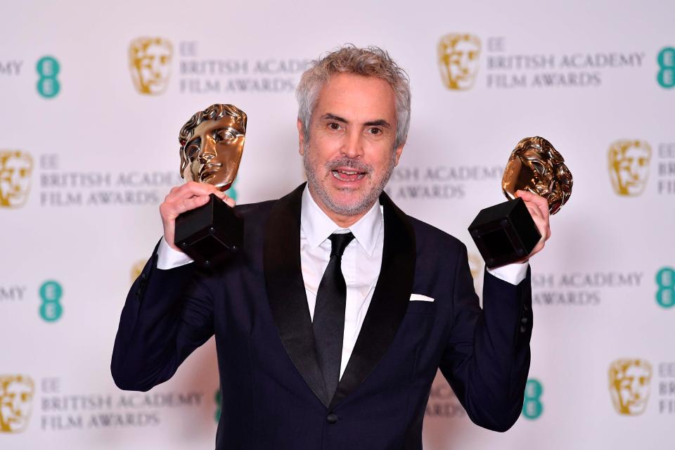  Romas director Alfonso Cuarón posed with its two awards, Best Film and Best Director