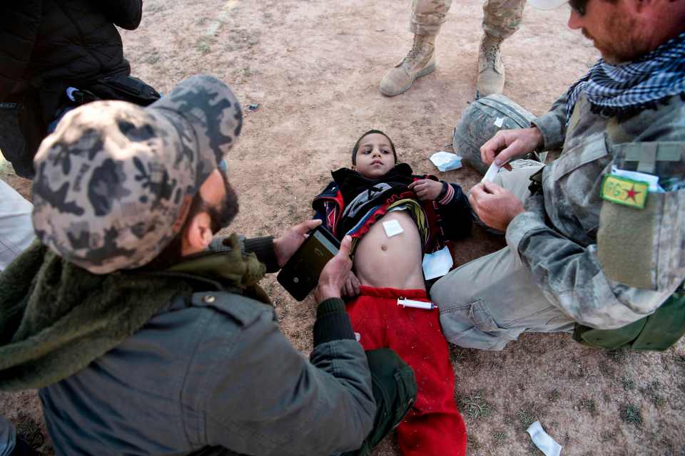  A child receives treatment as ISIS fighters make a last desperate stand