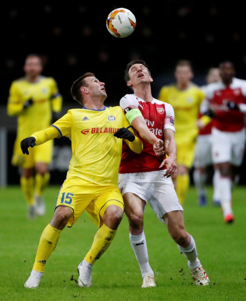  BATE Borisov's Maksim Skavysh tangles with Arsenal defender Laurent Koscielny