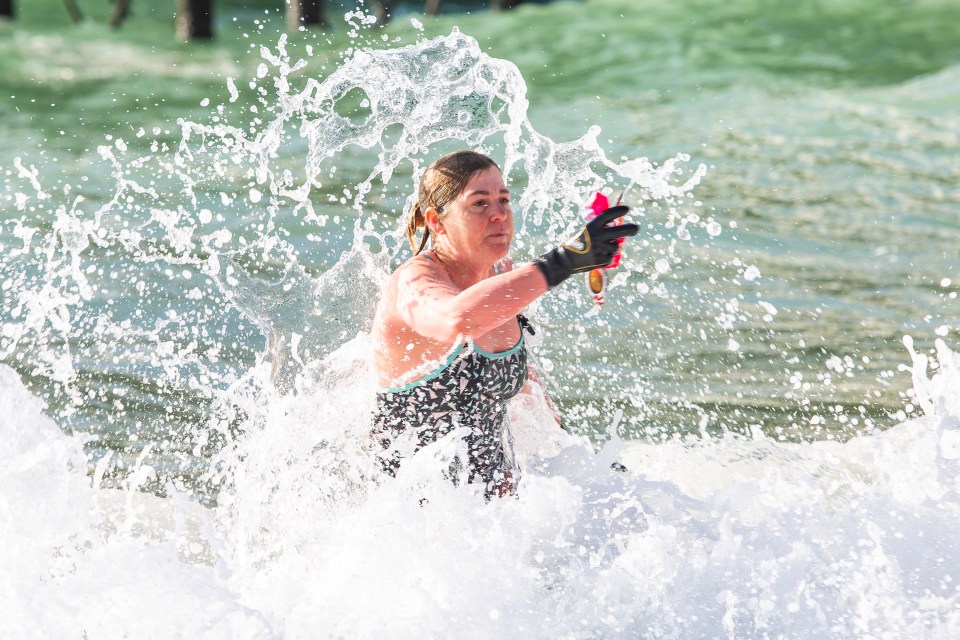  A member of the Brighton Swimming Club takes a dip in the sea