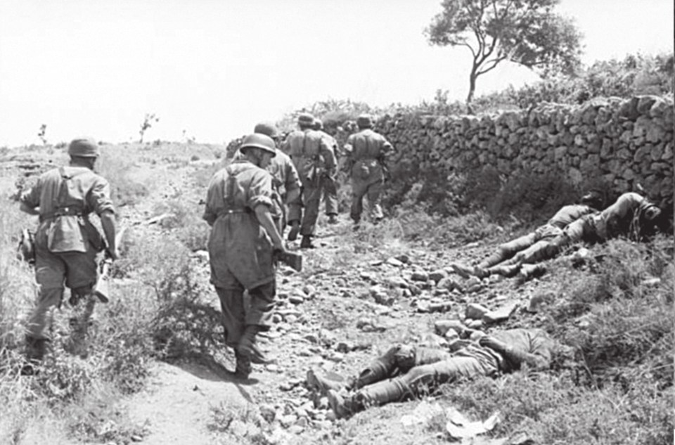  A German paratroop patrol passes by dead Allied soldiers in Greece in 1942