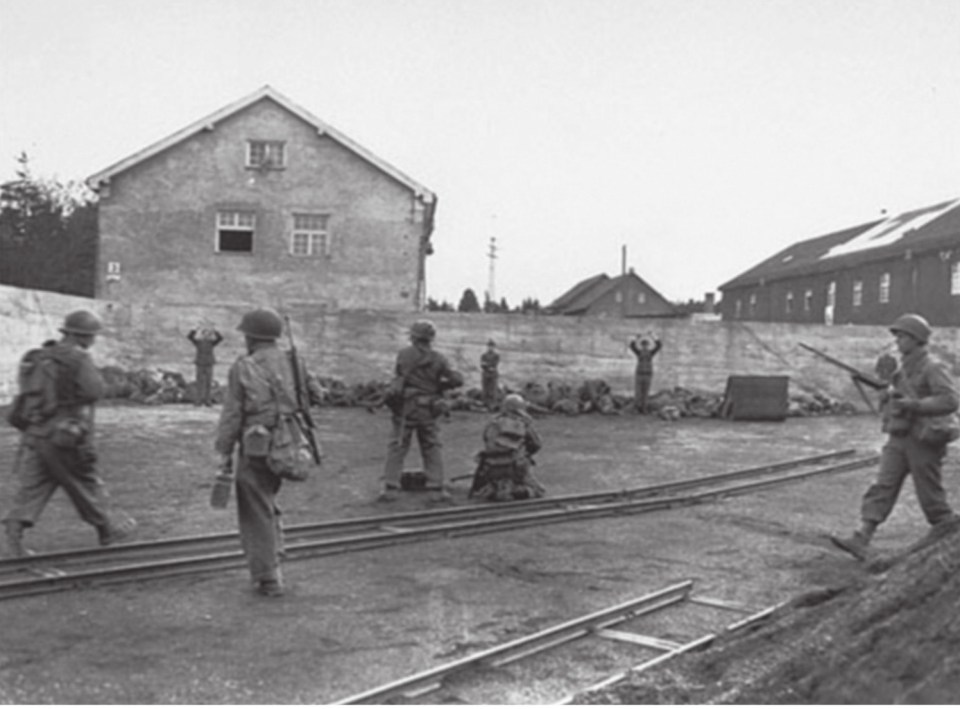  War crimes on both sides: German soldiers being executed by American troops outside Dachau, southern Germany, after the concentration camp was liberated