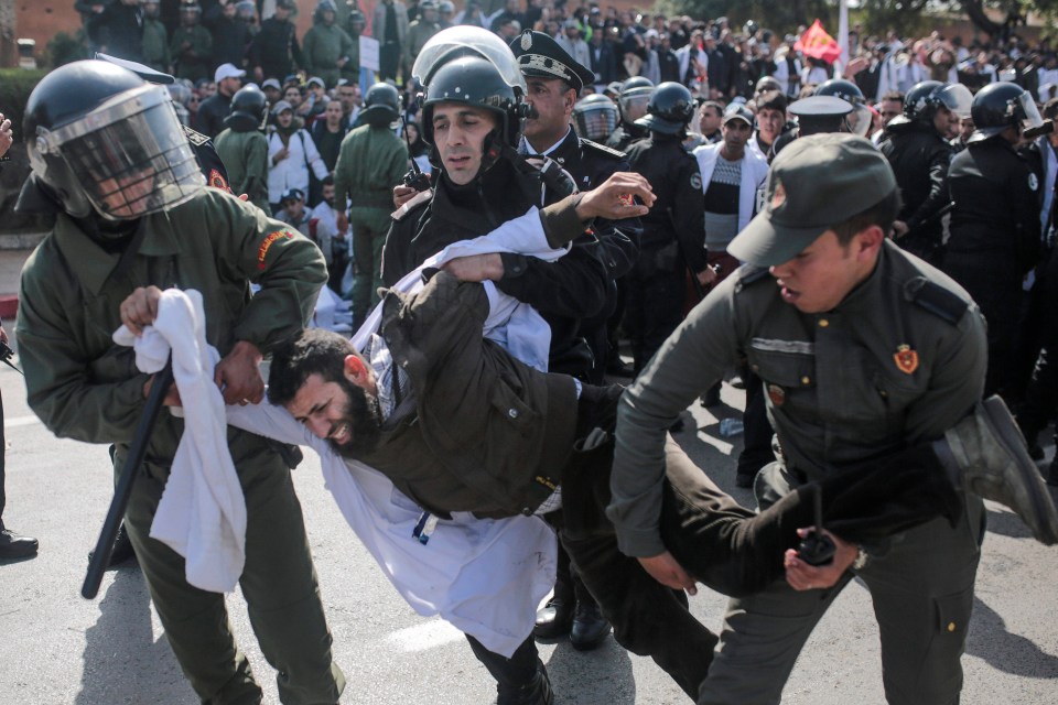  A man is dragged off my police in Morocco as they try to contain protests