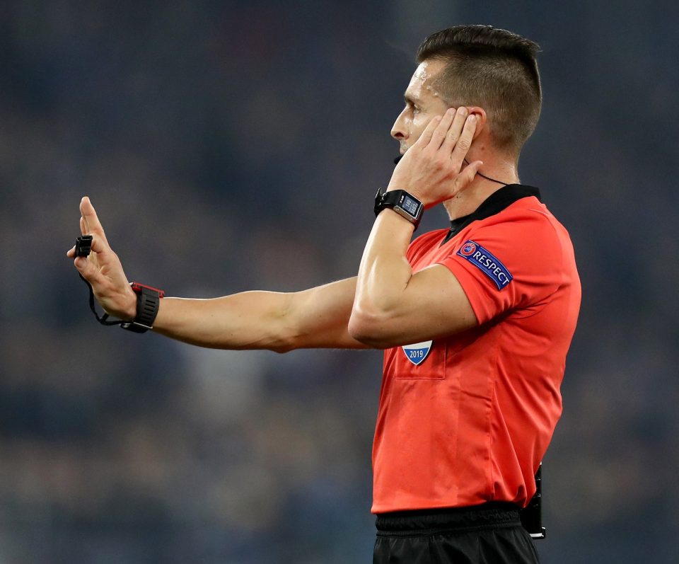  Referee Carlos del Cerro Grande stops play while he consults with the VAR