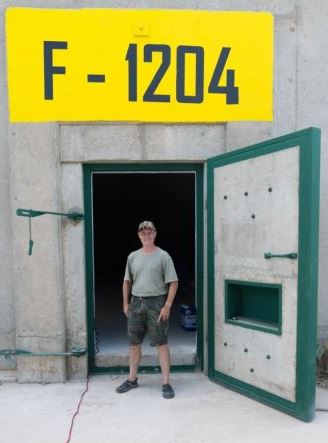  IT worker Tom Souslby, who fears civil unrest could destroy society soon, stands outside his bunker in South Dakota, in the US