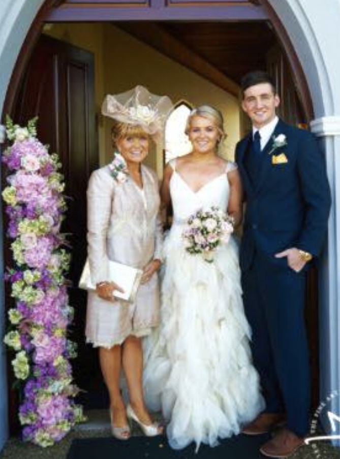  Naomi, pictured at her wedding, with her mum and brother