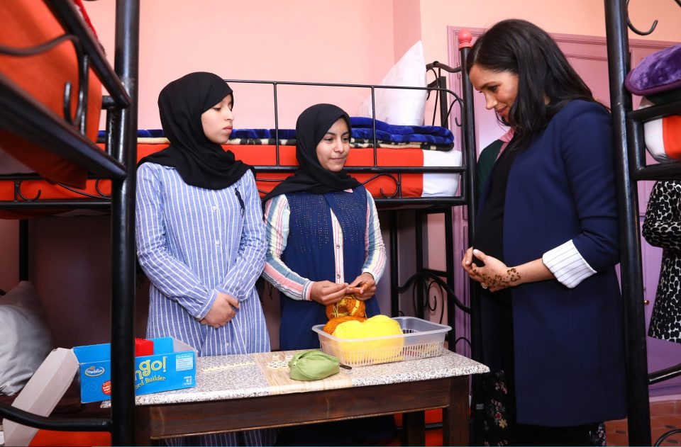  She cradled her baby bump as she met teenage pupils