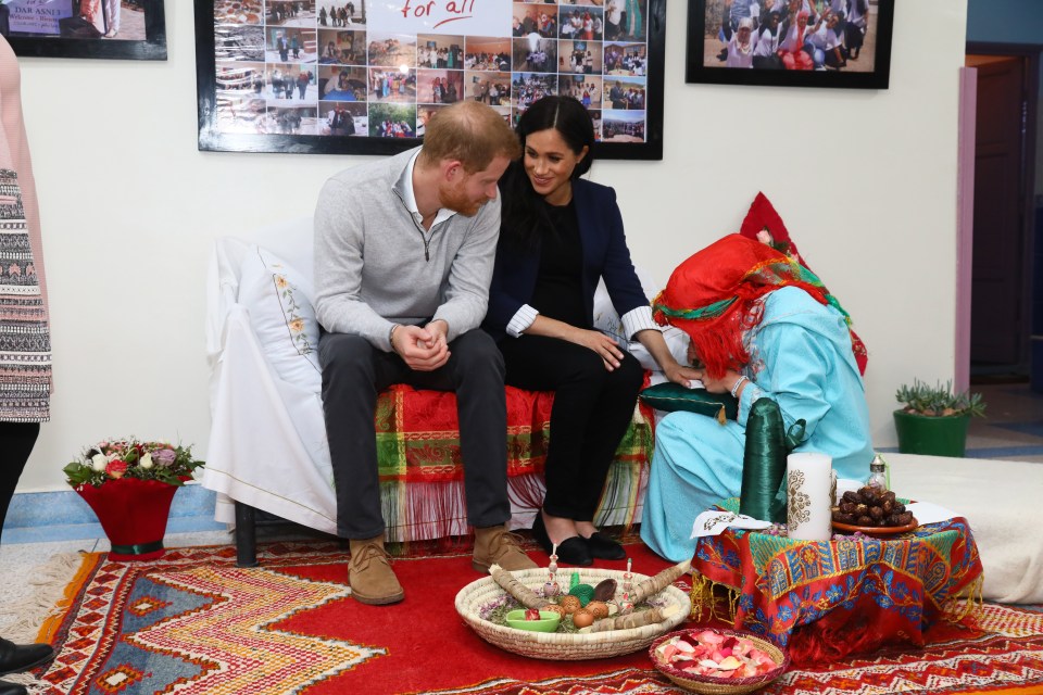 Earlier in the visit Meghan patiently sat while she got a henna design inked on her hand 