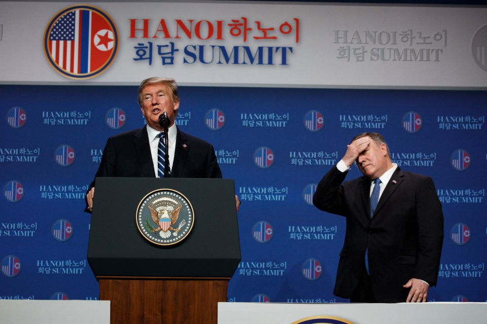  US Secretary of State Mike Pompeo wipes his forehead as Trump talks to reporters in Hanoi