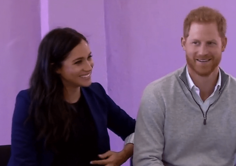 Meghan cradled her baby bump in the clip