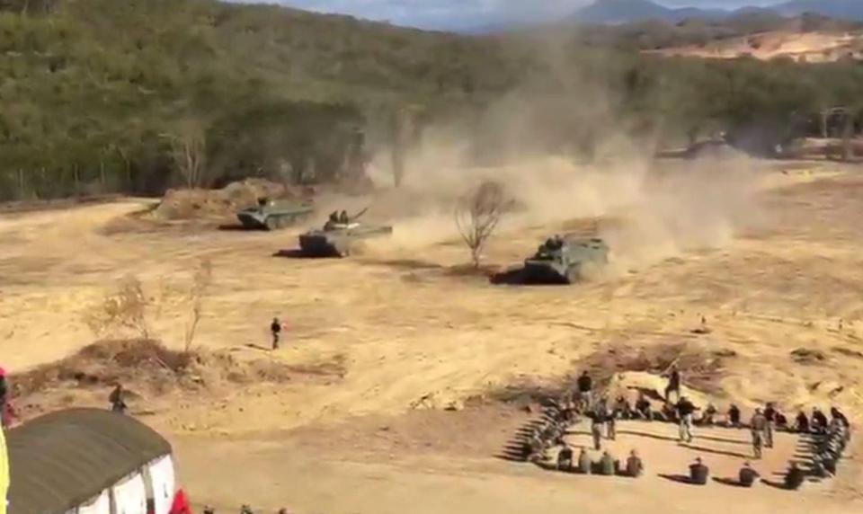  Tanks roll across a dusty plain during the drills